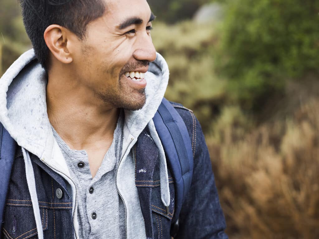 A young man smiling.